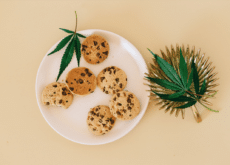 Cannabis leaves and cookies representing cannabinoid-infused consumer food products
