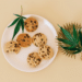 Cannabis leaves and cookies representing cannabinoid-infused consumer food products