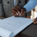 Business professionals reviewing and signing regulatory documents