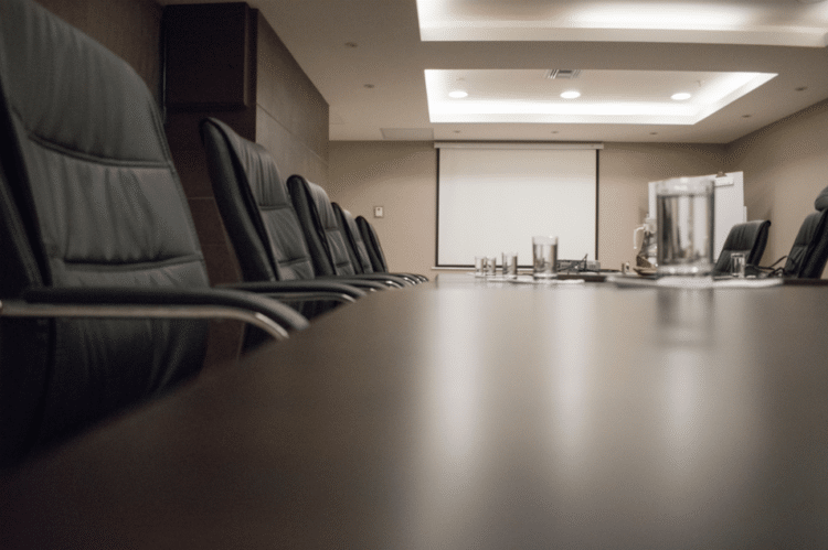 Empty executive conference room prepared for an industry roundtable on extraction regulation and manufacturing compliance.