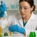 Laboratory technician using enzymes to extract natural compounds from plant material