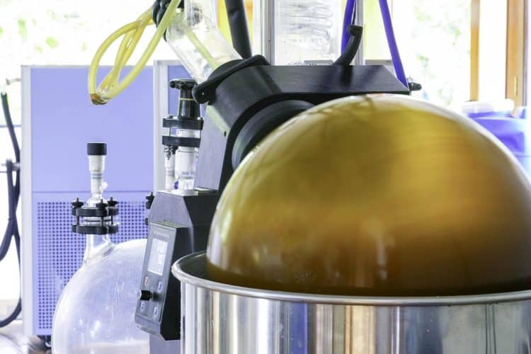 Industrial hybrid ultrasound-microwave extraction system showing 300% yield increase in modern botanical processing facility